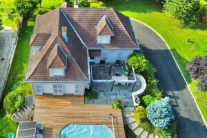 Aerial view of a home with swimming pool and landscaped yard