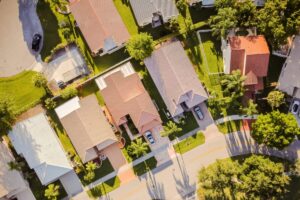 Aerial view of residential homes and tree-lined streets representing real estate values in Macon, GA