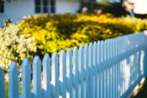 White picket fence and landscaped yard representing homes for sale in Macon, GA