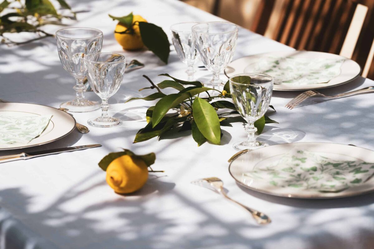 Country Club Dining Lifestyle Near Idle Hour Club Macon GA - Patti Chapman Real Estate™ Elegant country club dining table set with glassware, place settings, and fresh greenery